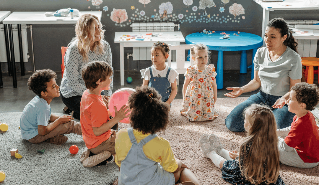 Teacher helping children practice kindness at a Christian daycare in North Raleigh