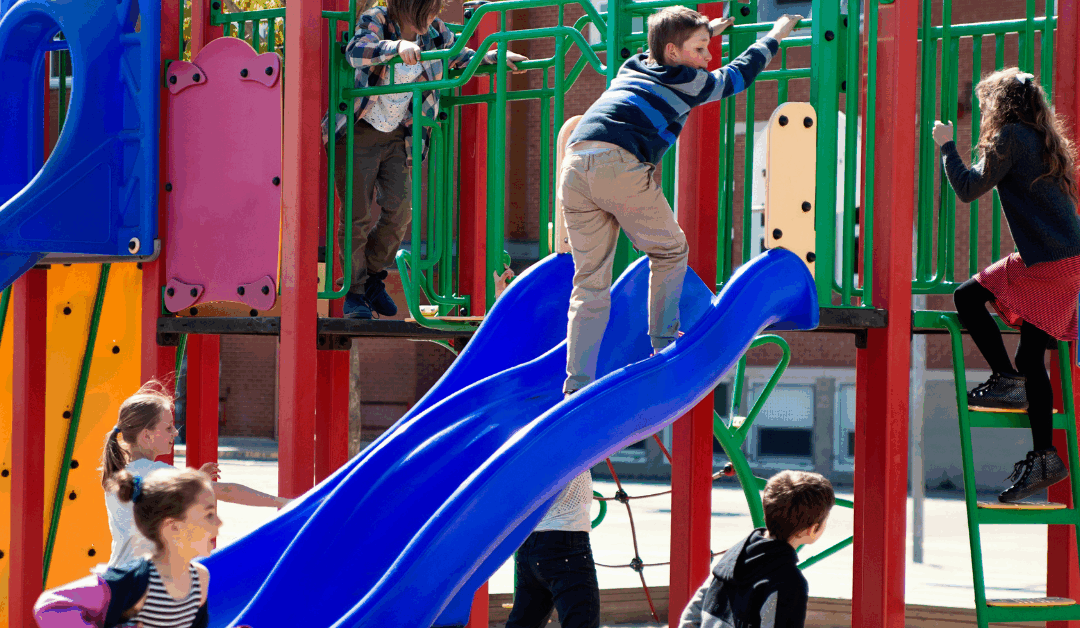Kids play on outdoor playground at daycare in North Raleigh